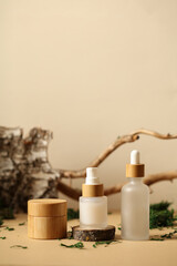 Wooden jars of moisturizer cream. with bark of birch, wood branch, green moss. SPA natural organic...