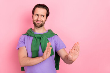 Photo of sad millennial beard man look empty space wear t-shirt green pullover isolated on pink...