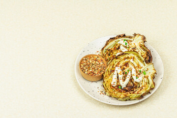 Homemade vegan cabbage steaks with herbs, spices, and sauce. Healthy food ready to eat