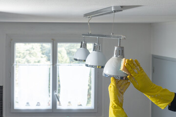 hands in gloves clean lamp