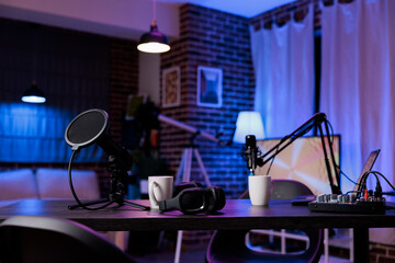 Nobody in living room used to record livestream show with podcast equipment for entertainment. Empty office space in apartment to film online videoblog, social media channel content. - obrazy, fototapety, plakaty