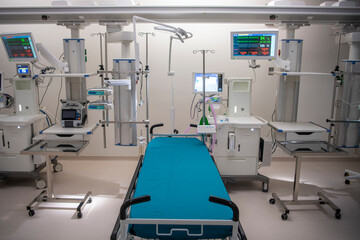 Empty Modern technology in intensive care unit room with different equipment and devices, beds and pillows.