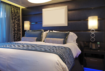 Bedroom of penthouse stateroom cabin suite in clean modern interior design onboard luxury...