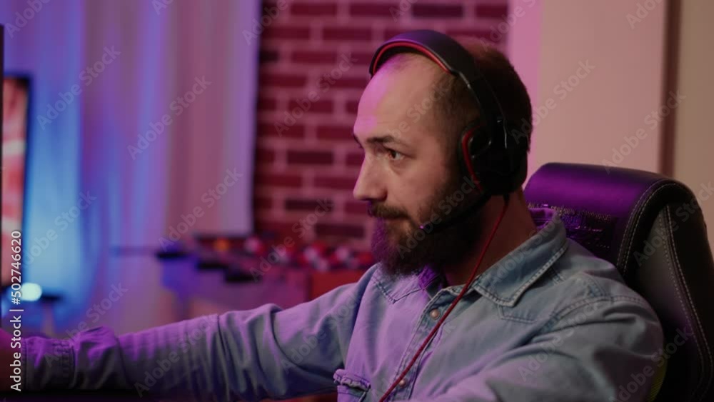 Poster closeup of man with gaming headset playing multiplayer online action game using professional pc setu