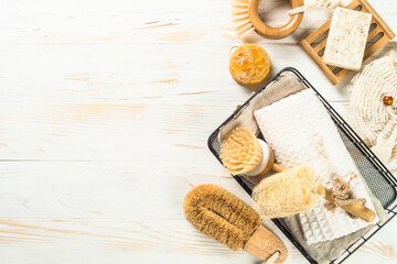 Fototapeta na wymiar Zero waste cleaning utensils for kitchen. Natural brushes, soap and towel. Reusable, sustainability, eco-friendly. Flat lay image at white wooden table.