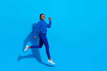 Fototapeta na wymiar Full length body size view of attractive cheerful girl jumping running copy space action isolated over bright blue color background