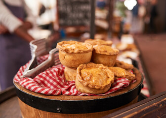 A barrel of chicken pies is on sale at a market