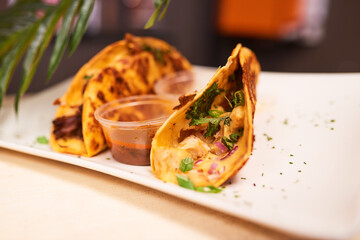 Close up of two soft shell cheesy tacos