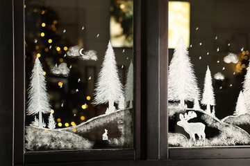 Beautiful drawing made with artificial snow on window. Christmas decor