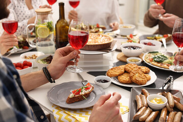 People having brunch together at table indoors, closeup