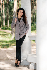 Female posing in pantsuit outdoors  Business woman portrait.
