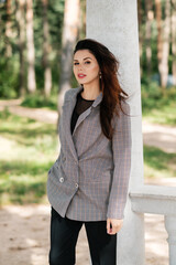 Female posing in pantsuit outdoors and looking at camera