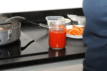 A natural crushed tomato preserve in a recycled glass jar. Selective focus