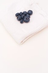 fresh organic blueberries on white kitchen towel