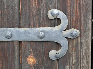 Decorative metal fittings on an old wooden gate