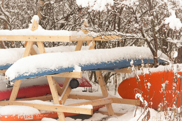 Kayaks stored outside in the Woods in Snow in Lofoten norway