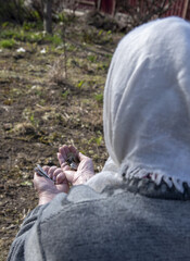 Small coins in the hands of an elderly woman.
