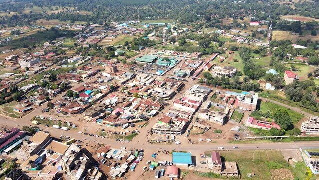 Aerial view of cars and people at a Open Air Market, in Africa - reverse, drone shot