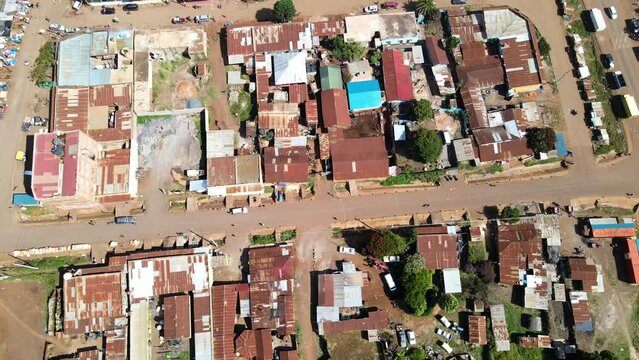 Aerial view of cars and people at a Open Air Market, in Africa - reverse, drone shot