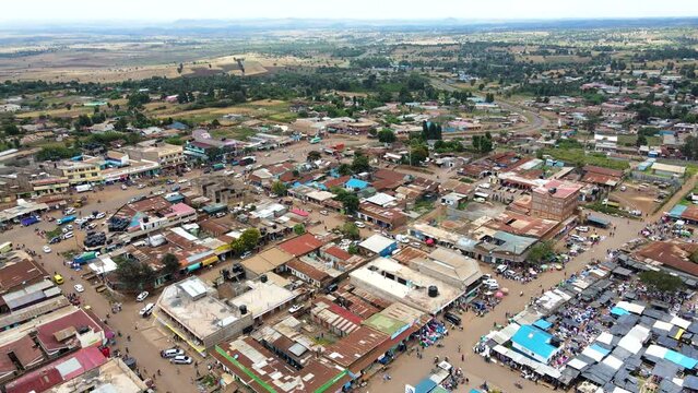 Aerial view of cars and people at a Open Air Market, in Africa - reverse, drone shot