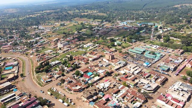 Aerial view of cars and people at a Open Air Market, in Africa - reverse, drone shot