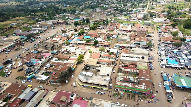 Aerial view of cars and people at a Open Air Market, in Africa - reverse, drone shot