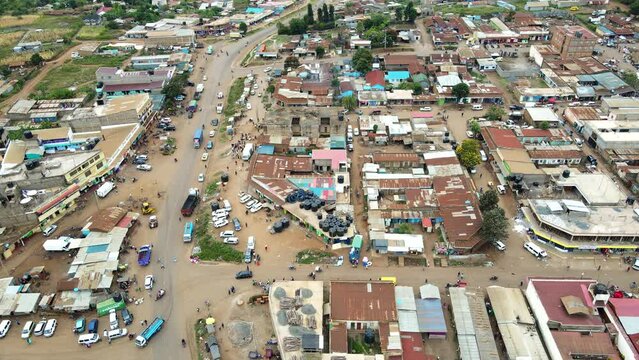 Aerial view of cars and people at a Open Air Market, in Africa - reverse, drone shot