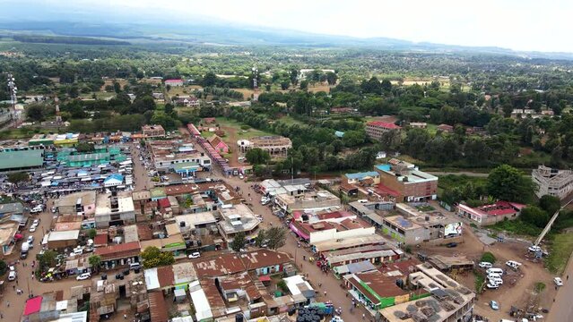 Aerial view of cars and people at a Open Air Market, in Africa - reverse, drone shot