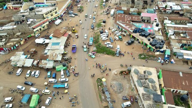 Aerial view of cars and people at a Open Air Market, in Africa - reverse, drone shot