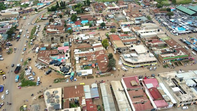Aerial view of cars and people at a Open Air Market, in Africa - reverse, drone shot