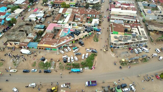 Aerial view of cars and people at a Open Air Market, in Africa - reverse, drone shot