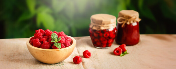 Fresh forest raspberries Raspberries with leaf on wooden table blur background. Copy space, wide panorama. Sweet raspberry homemade jam. 