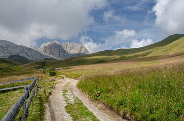 Fototapeta na wymiar Catinaccio d'Antermoia/Kesselkogel mountain [in front] as seen from Val de Dona [Dona valley] below on trail from Dona pass to Dona refuge, Catinaccio mountain group, Dolomites, South Tyrol, Italy