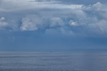 sailing boat on the sea, dramatic storm clouds over the sea