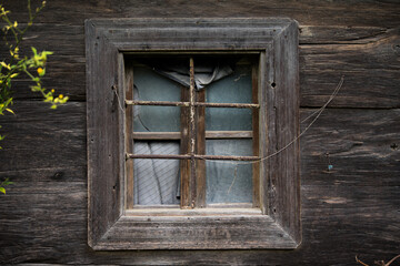 Fototapeta na wymiar Croatia, May 01,2022 : Rustic style aged window at rural home wall.