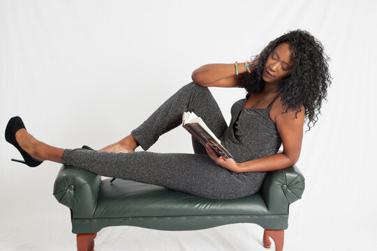 Lovely black woman sitting and reading a book