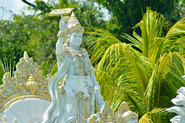 Fototapeta premium Fresh Warm Sunshine On Krishna Chakra Statue In The Garden