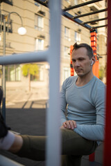 A man is engaged in sports outside on the playground, fitness, sport, lifestyle.