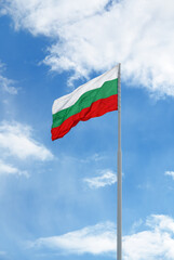 Flag of Bulgaria in front of blue sky and clouds