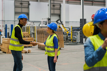 Two people greeting each other in a robotics store