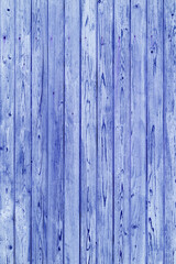 Vintage fence of old wooden boards. Texture of an aging wooden surface. Beautiful wooden background.