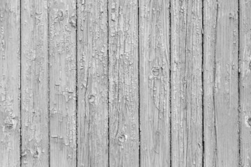 Vintage fence of old wooden boards. Texture of an aging wooden surface. Beautiful wooden background.