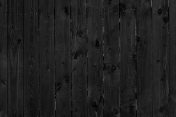 Vintage fence of old wooden boards. Texture of an aging wooden surface. Beautiful wooden background.