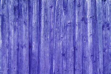 Vintage fence of old wooden boards. Texture of an aging wooden surface. Beautiful wooden background.