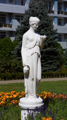 Statue of a woman with a jug and a saucer.