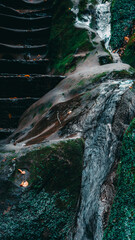 Stairway up, next to which water runs quietly.