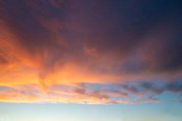 Naklejka na ściany i meble Dramatic sky with clouds at sunset, nature background