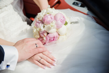 Closeup shot of a bridegroom holding bride's hand. Wedding ring. Tenderness concept