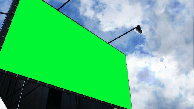 Big green billboard on the side of the screen against the sky. Keying. Mockup.