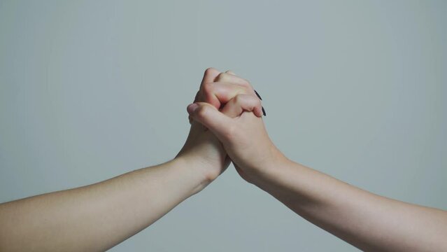 Male hand united in handshake. Woman help hands, guardianship, protection. Two hands, isolated arm, helping hand of a friend. Friendly handshake, friends greeting